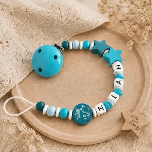 Attache tétine personnalisée turquoise avec prénom NAIM, motif Petit Prince, étoiles et clip assorti