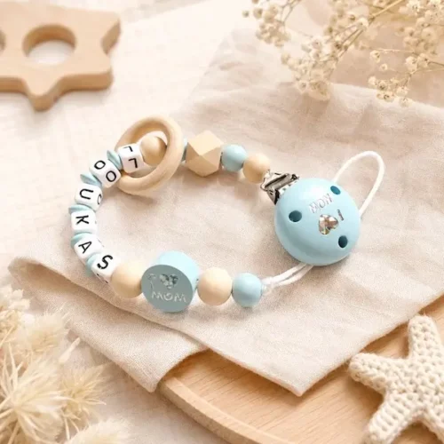 Attache tétine personnalisée Loukas en bois naturel et bleu layette avec anneau, perle MOM et clip assorti.